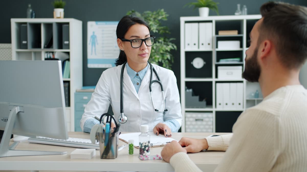 Physician and nurse reviewing patient data on tablet